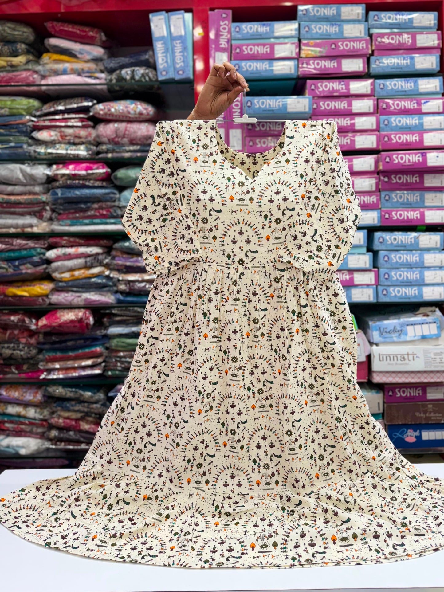Lace fabric displayed in a store with colorful boxes in the background